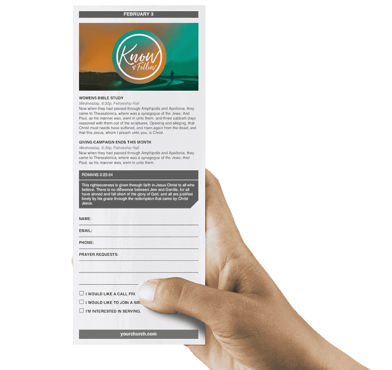 Hand holding a printed bulletin